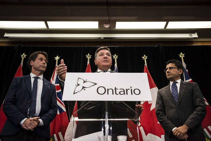 Minister of Finance, Charles Sousa, centre, Attorney General, Yasir Naqvi, right, and Minister of Health and Long-Term Care, Eric Hoskins speak during a press conference where they detailed Ontario's solution for recreational marijuana sales, in Toronto last Friday.