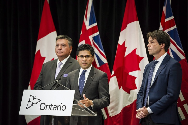 Attorney General Yasir Naqvi, centre, Minister of Finance Charles Sousa, left, and Minister of Health and Long-Term Care Eric Hoskins speak during a press conference where they detailed Ontario's solution for recreational marijuana sales, in Toronto on Friday. 