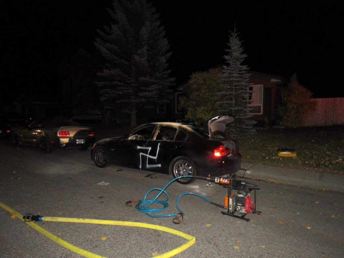 Officers on patrol in the 5000 block of 22 Avenue N.E. on Tuesday found a car that had been set on fire and covered with hateful messages.