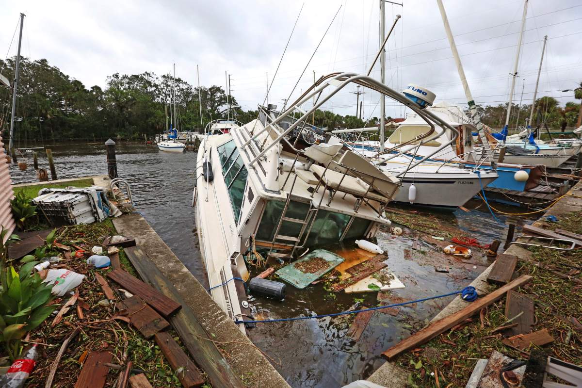 A sinking boat is surrounded by debris in the aftermath of Hurricane Irma at Sundance Marine in Palm Shores, Fla., Monday, Sept. 11, 2017