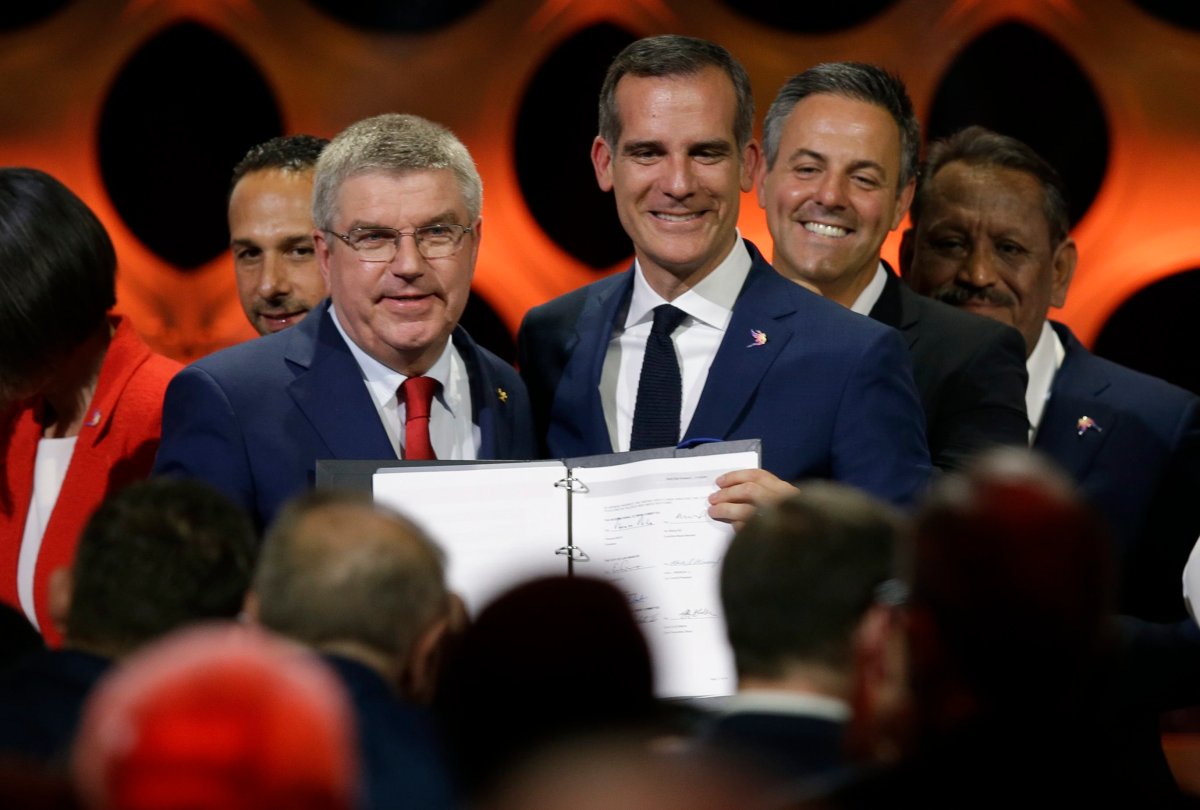 International Olympic Committee President Thomas Bach (IOC), left, poses with Los Angeles Mayor Eric Garrett at the end of an IOC session in Lima, Peru, Wednesday, Sept. 13, 2017. The IOC is voting to ratify Los Angeles as the host city of the 2028 Olympic and Paralympic Games and Paris as the host city of the 2024 Games during the IOC Session. (AP Photo/Martin Mejia).