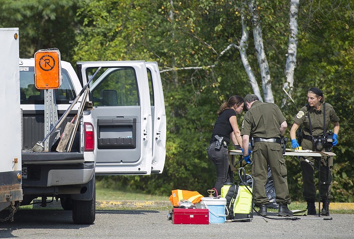 Quebec provincial police officers search for evidence next to a truck in Lachute, Quebec on Friday, September 15 , 2017 in connection with an Amber Alert. A Quebec man who was arrested in Ontario in connection with the alleged abduction of his six-year-old son has been taken to hospital for an unspecified injury after a court appearance on Saturday morning. Sep. 16, 2017.