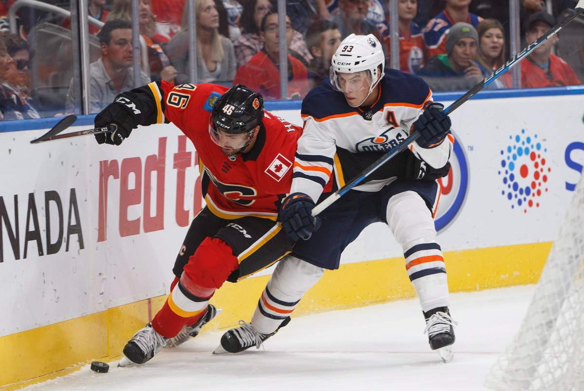 Calgary Flames forward Marek Hrivik (46) and Edmonton Oilers forward Ryan Nugent-Hopkins (93) during first period NHL preseason split-squad hockey action in Edmonton, Alta., on Monday September 18, 2017. 