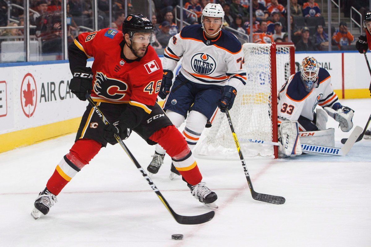 Calgary Flames forward Marek Hrivik (46) is chased by Edmonton Oilers defenceman Ethan Bear (74) as goalie Cam Talbot looks for the puck during first period NHL preseason split-squad hockey action in Edmonton, Alta., on Monday September 18, 2017. 