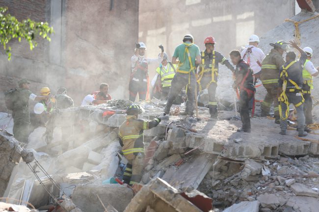 First responders work on removing the rubble of a collapsed building looking for survivors trapped underneath, after a 7.1 earthquake in Mexico City, Tuesday, Sept. 19, 2017.  The earthquake stunned central Mexico, killing more than 100 people as buildings collapsed in plumes of dust.