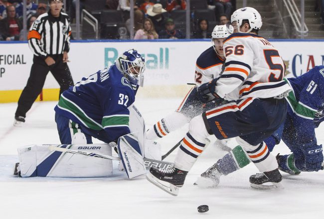 Vancouver Canucks' goalie Richard Bachman (32) makes the save on Edmonton Oilers' Kailer Yamamoto (56) during second period pre-season NHL action in Edmonton, Alta., on Friday September 22, 2017. 