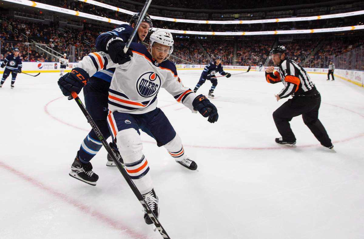 Winnipeg Jets' Brendan Lemieux (48) and Edmonton Oilers' Dillon Simpson (79) battle in the corner during third period pre-season NHL action in Edmonton, Alta., on Saturday September 23, 2017. 