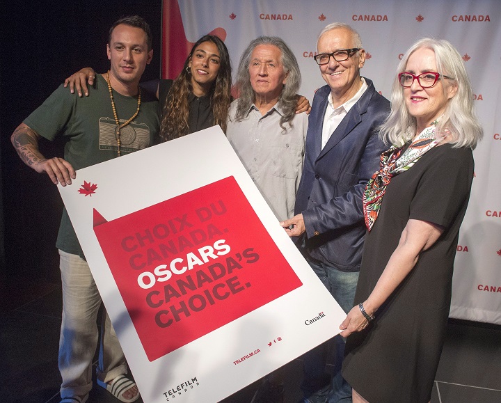 Actors, from left, Samian, Naiade Aoun, and Wahiakeron Gilbert, as well as producer Roger Frappier, and Telefilm Canada's executive director Carolle Brabant, pose for photos after the film "Hochelaga, Land of Souls," was named as Canada's entry in the race for the 2018 Best Foreign Language Film Oscar Monday, September 25, 2017 in Montreal.