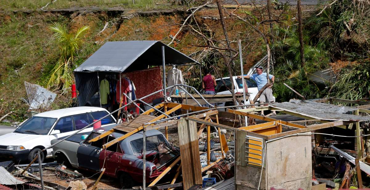 Jose Garcia Vicente, right, works with Jose Colon, as he starts to salvage his destroyed home, in the aftermath of Hurricane Maria, in Aibonito, Puerto Rico, Monday, Sept. 25, 2017.