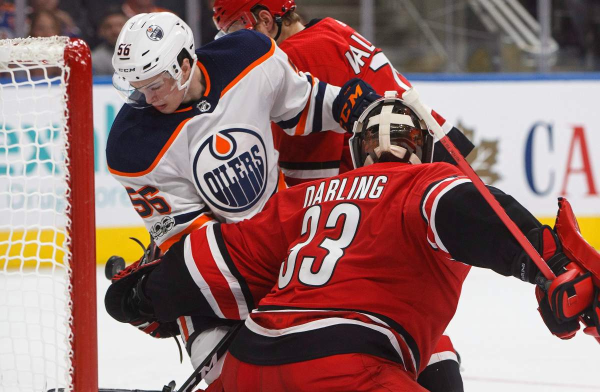 Carolina Hurricanes goalie Scott Darling (33) makes the save as Edmonton Oilers' Kailer Yamamoto (56) looks for the rebound during second period preseason NHL action in Edmonton, Alta., on Monday September 25, 2017. 