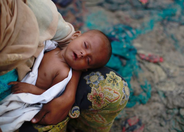 A Rohingya refugee boy sleeps after arriving at Thaingkhali makeshift refugee camp in Cox's Bazar, Bangladesh, Sept. 14, 2017. 