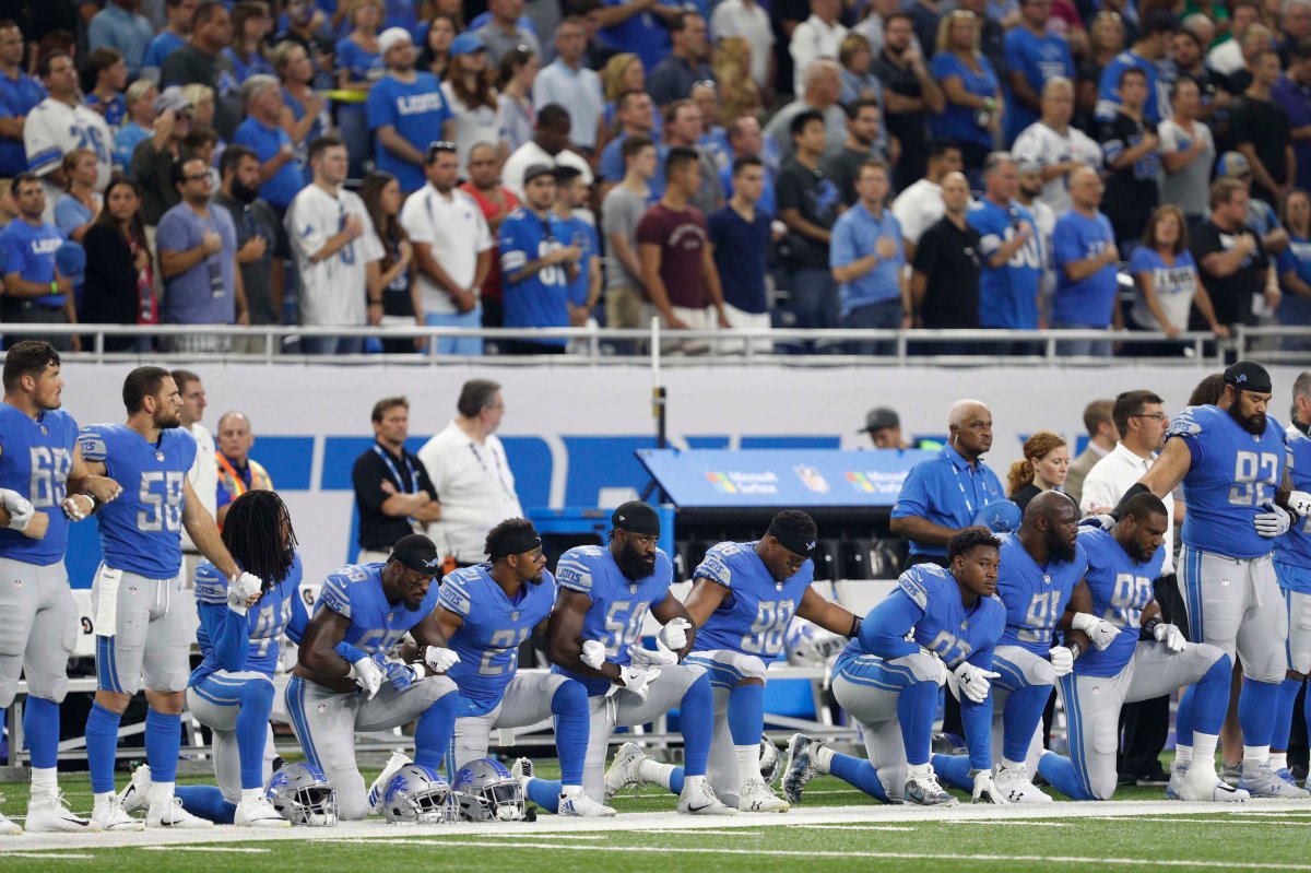 Detroit Lions players kneel.