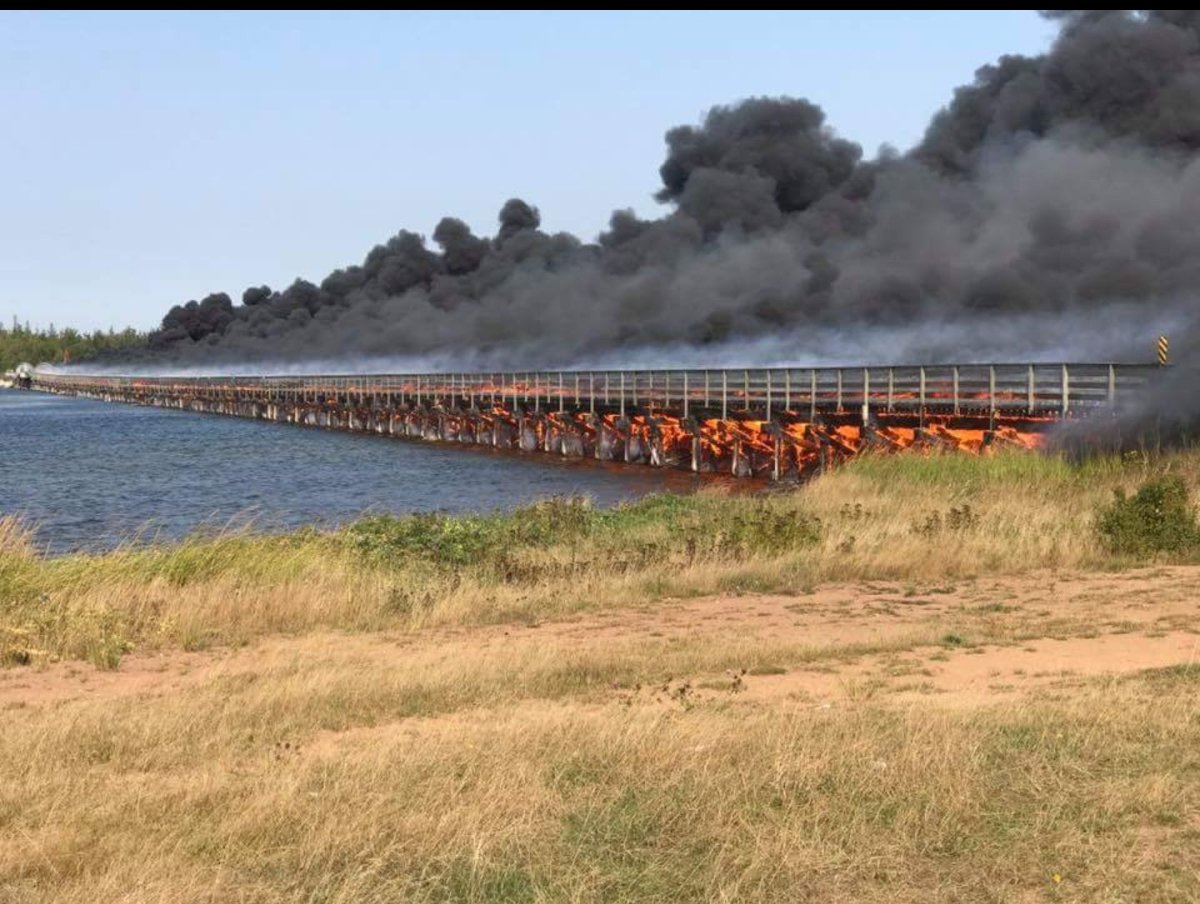 New Brunswick RCMP are investigating the fire that consumed this bridge in Inkerman, N.B.