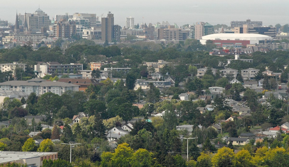 A view across housing to the skyline in downtown Victoria, British Columbia from the park on top of Mt. Tolmie. The large white building at top, right is the Save On Foods Memorial Arena. 