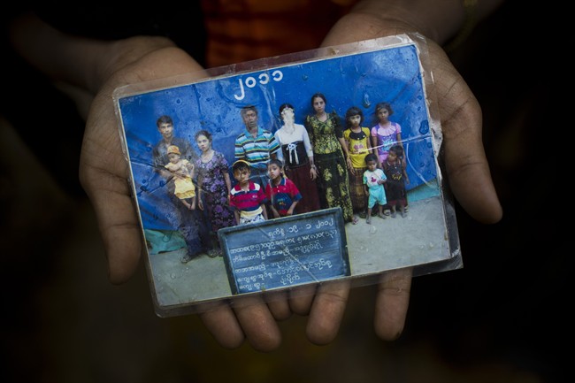 Rohingya Mubarak Begum, who crossed over from Myanmar into Bangladesh, holds a photograph of her family members, in Kutupalong, Bangladesh, Friday, Sept. 8, 2017.