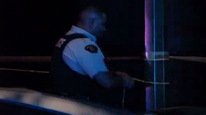 Burnaby RCMP officer taping off a crime scene