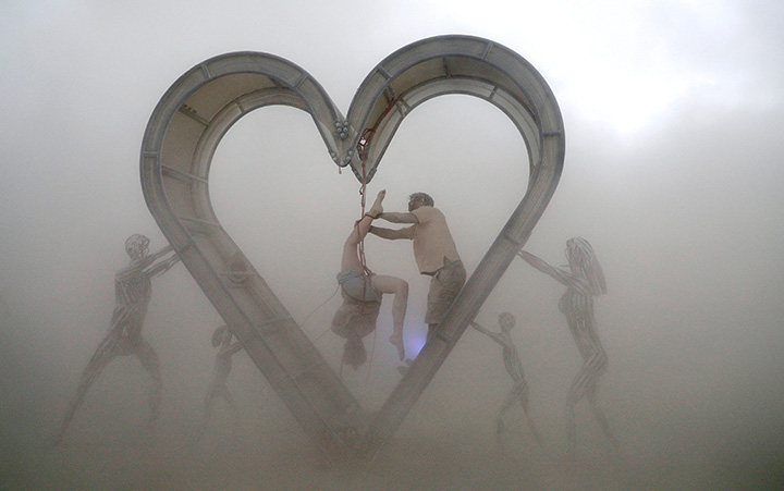 Burning Man participants perform during a driving desert dust storm on the 2nd day of the annual Burning Man arts and music festival in the Black Rock Desert of Nevada, August 29, 2017.