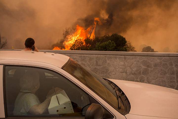 Residents on the 210 Freeway try to view their house on the other side of thick smoke and flames near the community of Tujunga during the La Tuna Fire on September 2, 2017 in California.