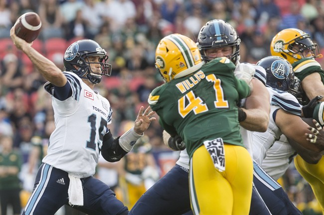 Toronto Argonauts quarterback Ricky Ray, left, looks to make a pass during second half CFL football action against the Edmonton Eskimos in Toronto on Saturday, September 16, 2017. THE CANADIAN PRESS/Chris Young.