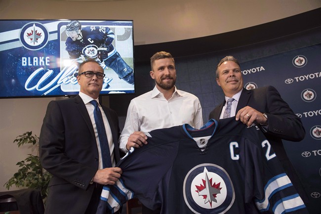 Winnipeg Jets head coach Paul Maurice, left to right, forward Blake Wheeler and general manager Kevin Cheveldayoff pose for a photo during a press conference in Winnipeg on Wednesday, August 31, 2016. The Winnipeg Jets have signed head coach Maurice and Cheveldayoff to multi-year contract extensions.