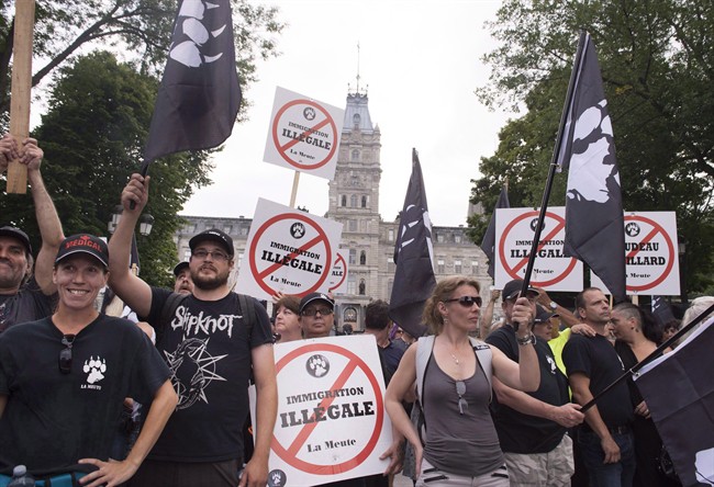 Demonstrators of a right wing group, "La Meute" demonstrate in silence in front of the legislature, Sunday, August 20, 2017 in Quebec City.