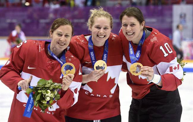Canada's Jayna Hefford, left to right, Haley Irwin and Gillian Apps show off their gold medals after defeating Team USA in the womens gold medal hockey game at the Sochi Winter Olympics in Sochi, Russia, on February 21, 2014.