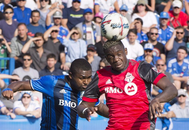 Montreal Impact's Chris Duvall, left, challenges Toronto FC's Chris Mavinga during first half MLS soccer action in Montreal on August 27, 2017. 