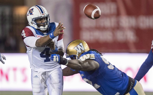 Montreal Alouettes quarterback Darian Durant releases the ball as he is tackled by Winnipeg Blue Bombers defensive tackle Drake Nevis during second quarter CFL football action Thursday, August 24, 2017 in Montreal. The Alouettes thought they had solved their quarterback troubles when they acquired veteran Durant from Saskatchewan, but the team is 3-7 and has been held without an offensive touchdown in two of its last three games.