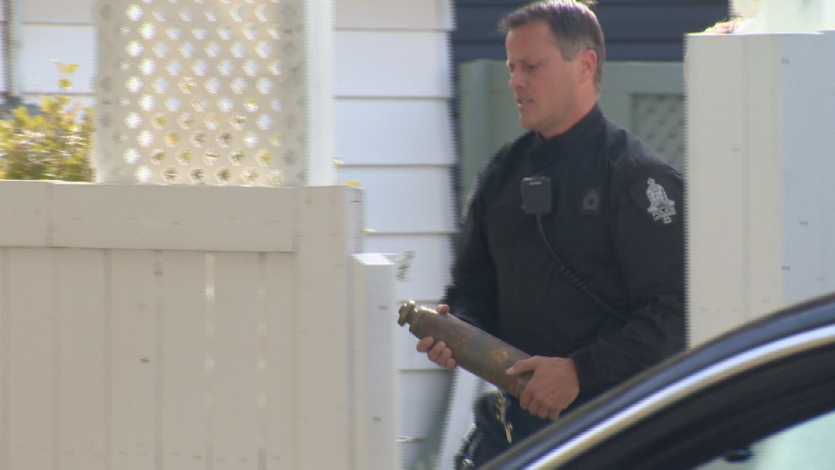 A Lethbridge police officer removes an explosive device from a home on Monday, Sept. 25. 