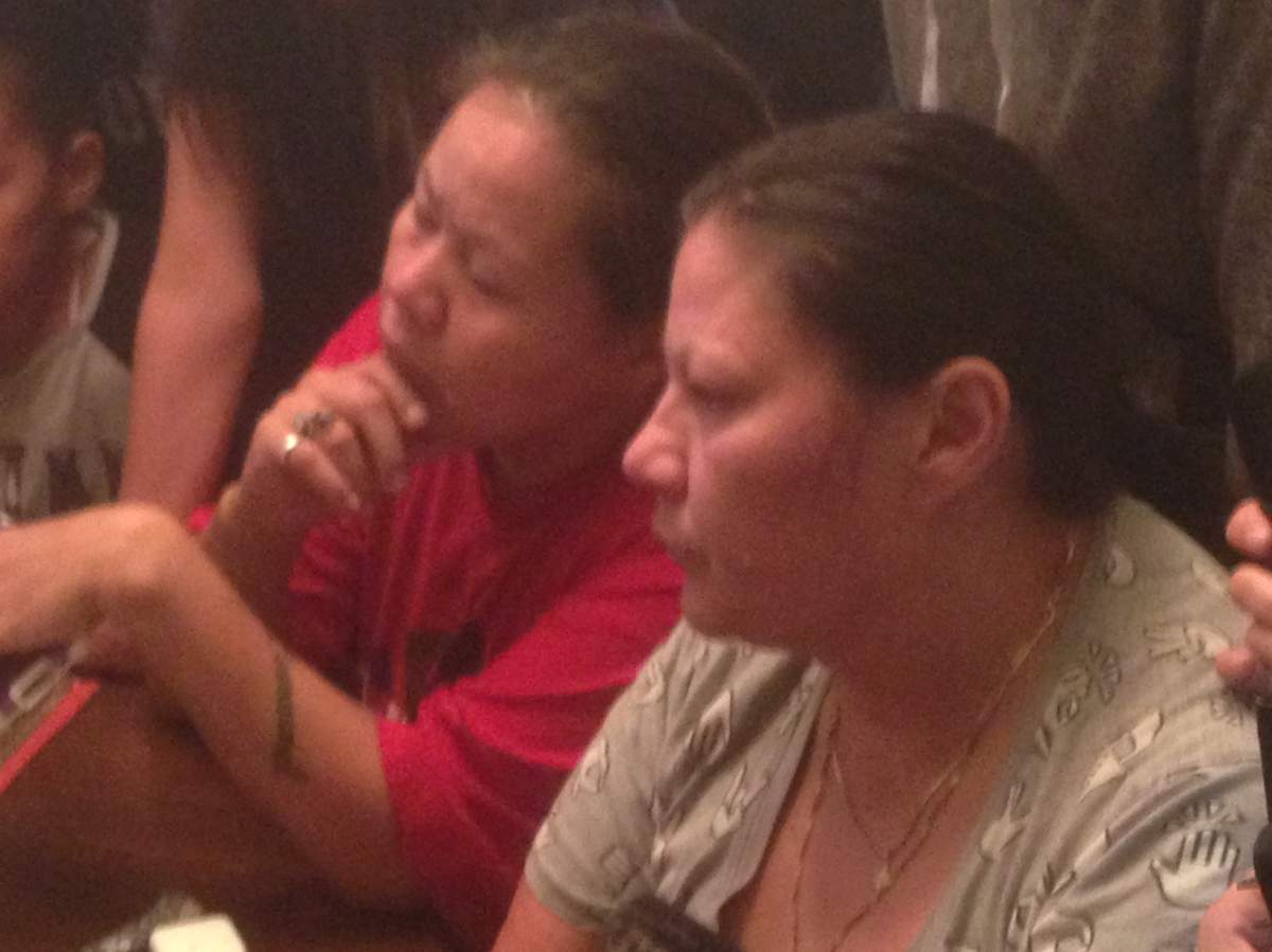 Lacquette’s family members listen to the Wednesday morning police briefing.