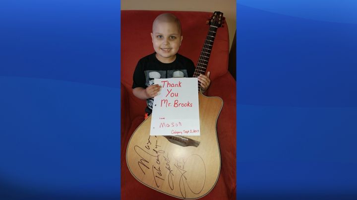 Garth Brooks gives signed guitar to mom of boy fighting ...