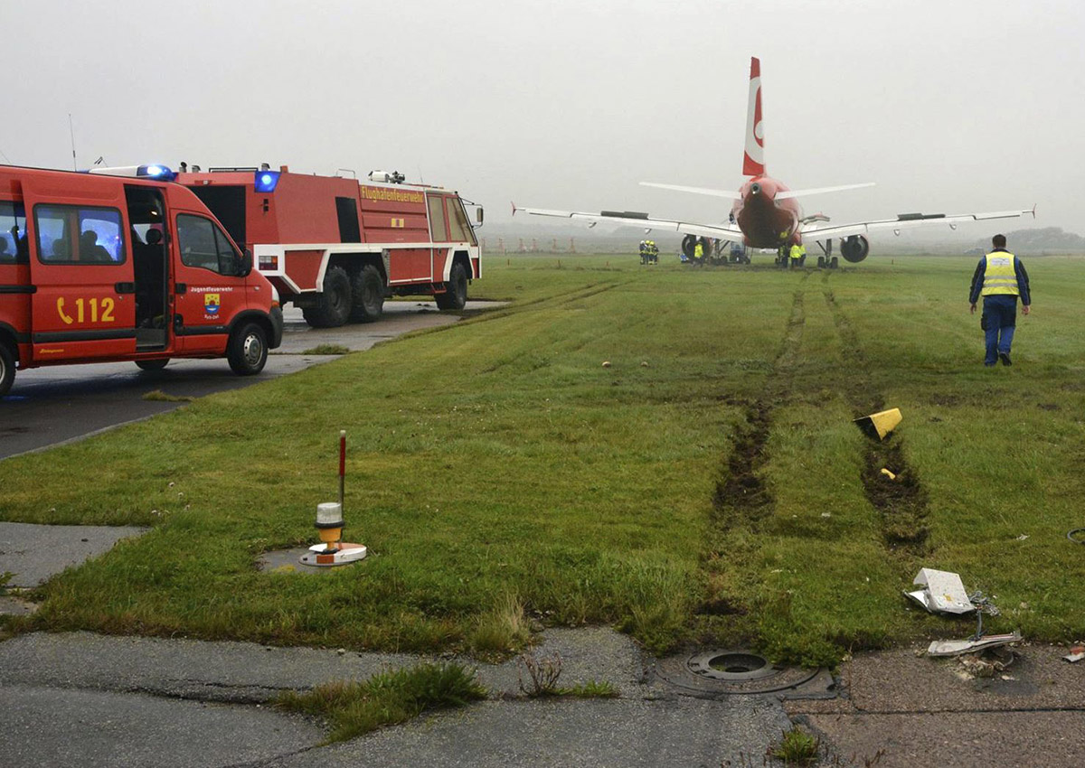 In this picture released by the fire brigade Westerland ( Freiwillige Feuerwehr Westerland), an Airbus of Air Berlin stands in a meadow near Westerland on the German North Sea island of Sylt, Saturday, Sept. 30, 2017. 