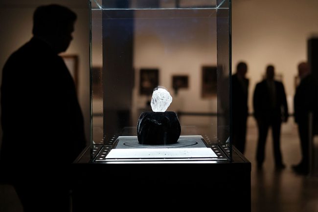 Guards stand next to the 1109-carat rough Lesedi La Rona diamond, the biggest rough diamond discovered in more than a century, at Sotheby's on May 04, 2016 in New York City. 

