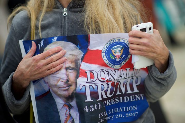 A supporter clutches a Donald Trump themed flag after he was sworn in as the 45th President of the United States on the National Mall Jan. 20, 2017 in Washington D.C.