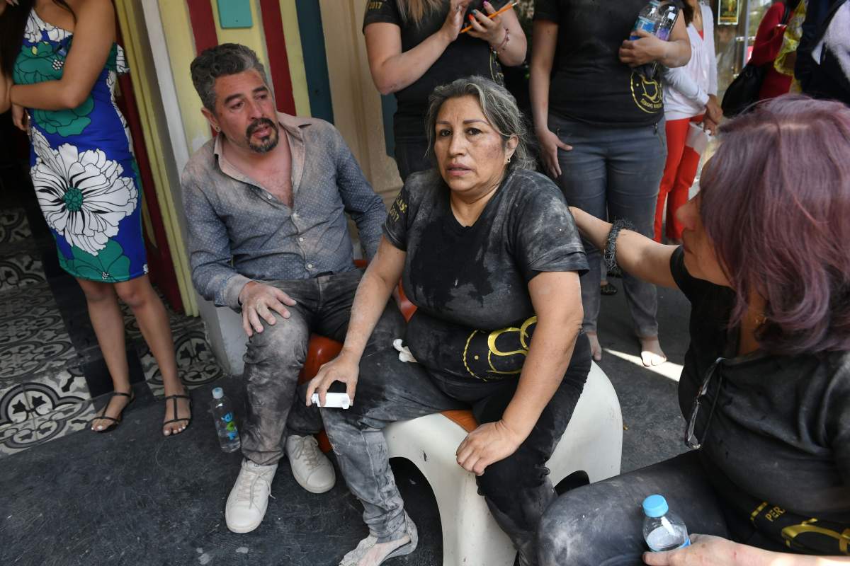 People are assisted after being injured during a quake in Mexico City on September 19, 2017.