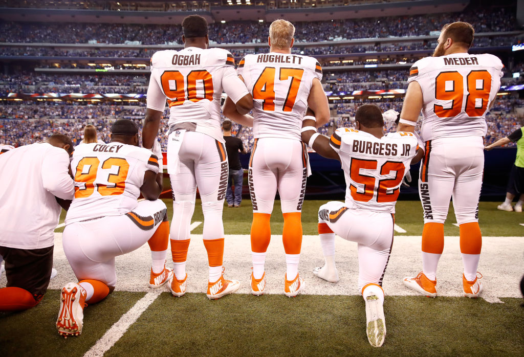 Members of the Cleveland Browns stand and kneel during the national anthem on September 24, 2017 in Indianapolis, Indiana.