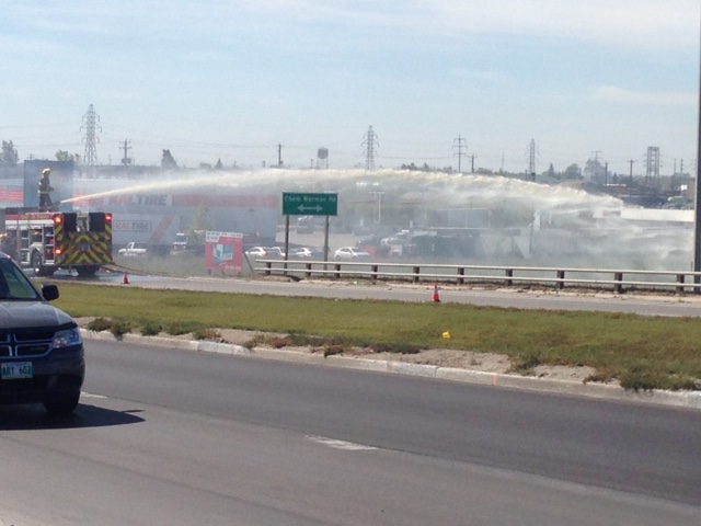 Winnipeg fire crews battle a grass fire near Lagimodiere Boulevard Monday. 