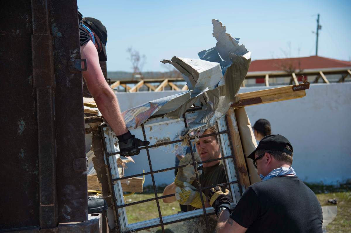 The crew of HMCS St. John’s and Royal Marines members work together to clean-up a school in South Caicos Island.