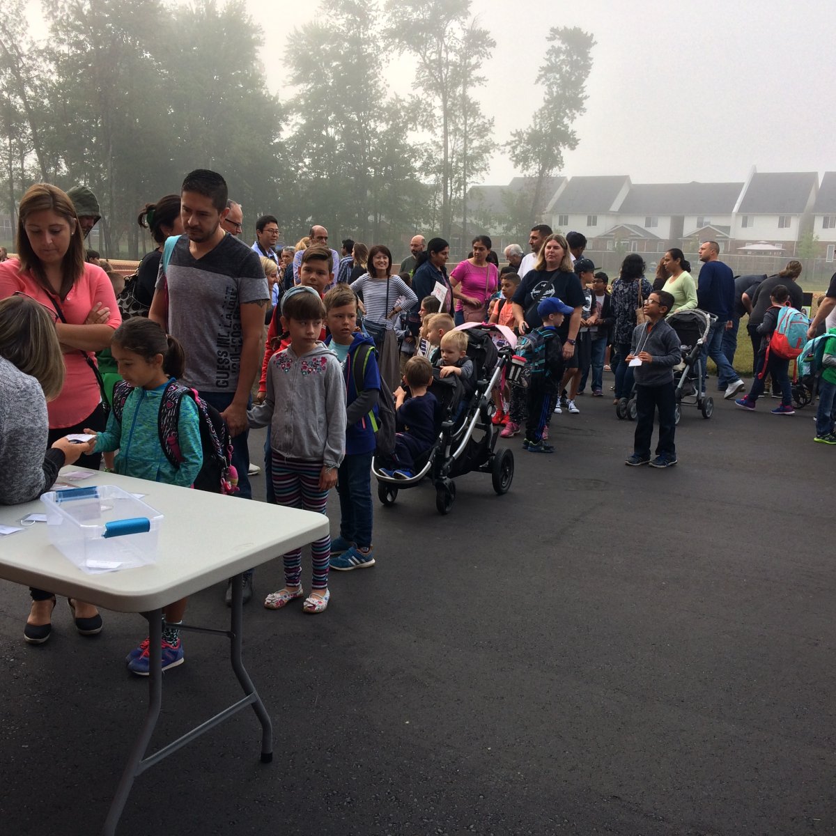 Parents and guardians and their children arrive for the first day of school at Sir Arthur Currie in London, Ont.