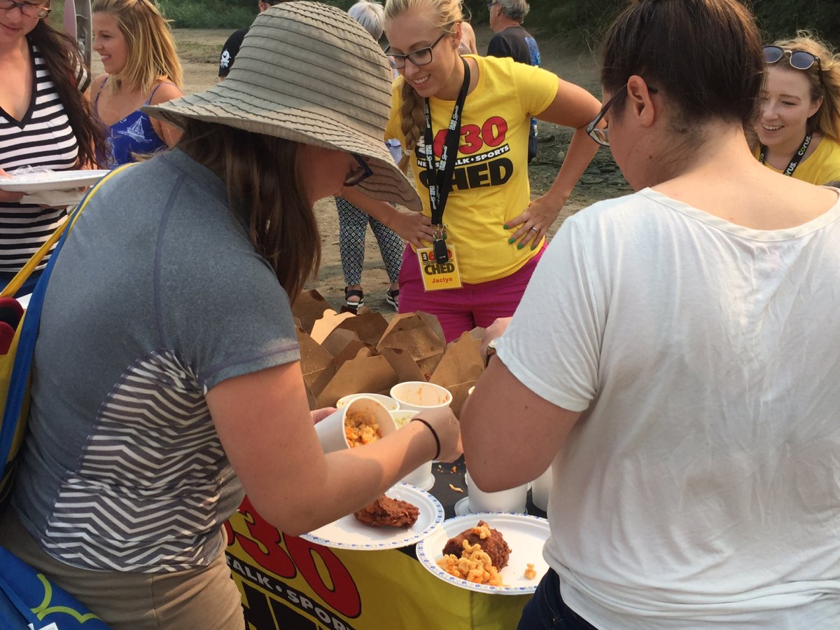 Listeners at the 630 CHED Endless Summer Accidental Beach Party enjoy lunch supplied by Northern Chicken.