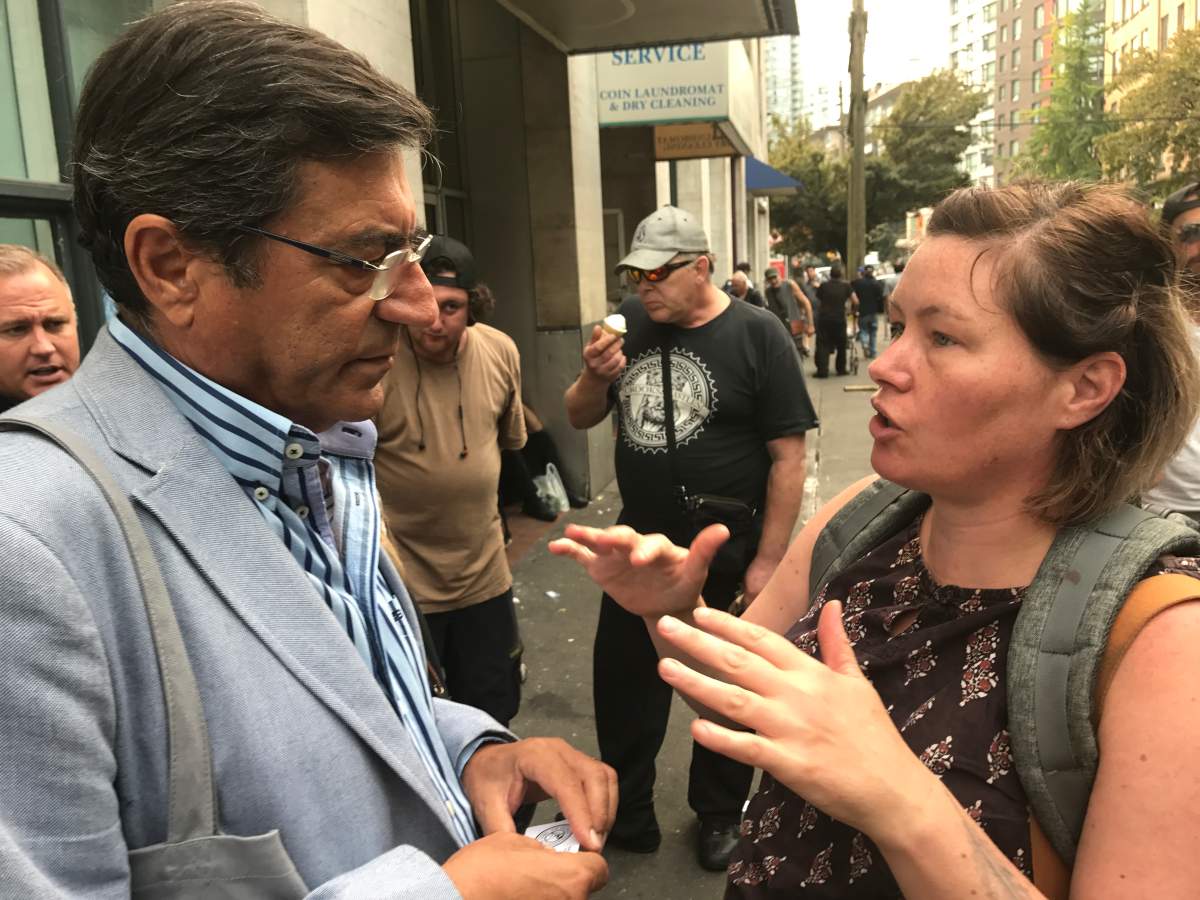 Dr. João Goulão speaks to advocate Sarah Blyth during his visit to the DTES.