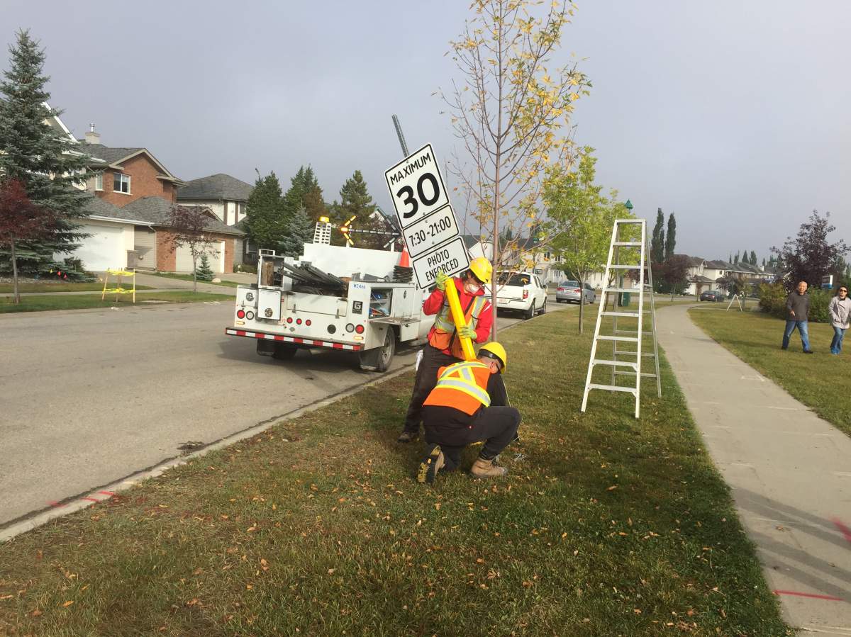 City of Edmonton crews install new 30 km/h speed limit signs in the Haddow neighbourhood in southeast Edmonton on Sept. 15, 2017.