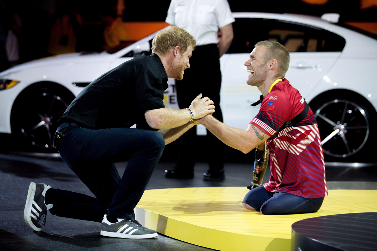 Prince Harry congratulates Mark Ormrod of the UK on his silver medal in indoor rowing at the Invictus Games in Toronto on Tuesday, Sept. 26, 2017. 