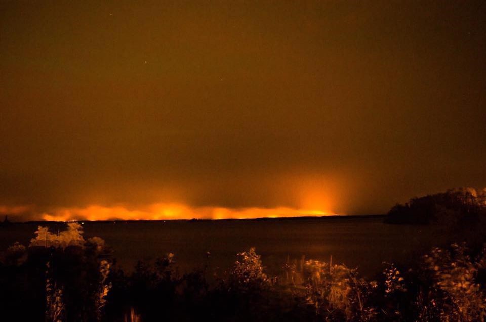 The red glow of a wildfire that forced thousands to evacuate in Manitoba.
