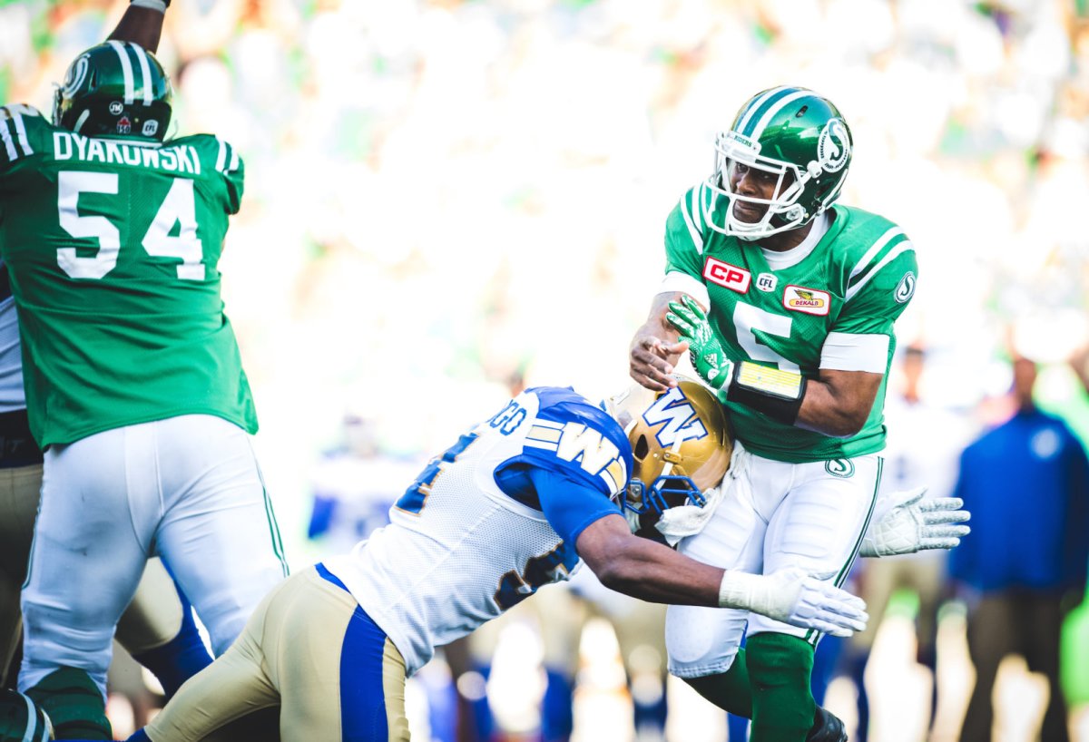 Kevin Glenn (5) of the Saskatchewan Roughriders and Tristan Okpalaugo (54) of the Winnipeg Blue Bombers during the Labour Day Classic game at Mosaic Stadium in Regina SK, Sunday September 3, 2017.
