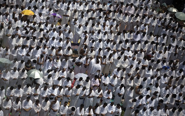 Muslim pilgrims attend noon prayers outside the Namirah mosque on Arafat Mountain, during the annual hajj pilgrimage, outside the holy city of Mecca, Saudi Arabia, Thursday, Aug. 31, 2017.