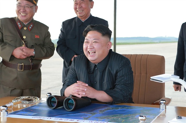 In this undated photo distributed on Saturday, Sept. 16, 2017, by the North Korean government, leader Kim Jong Un attends what was said to be the test launch of an intermediate range Hwasong-12 missile at an undisclosed location in North Korea. 