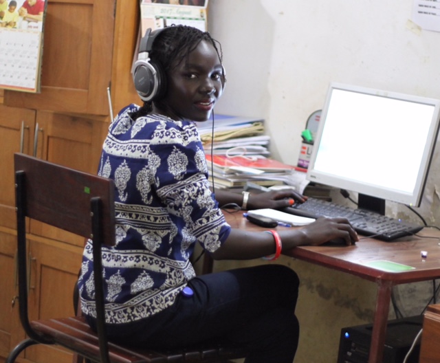 Maura Ajak at a computer. 