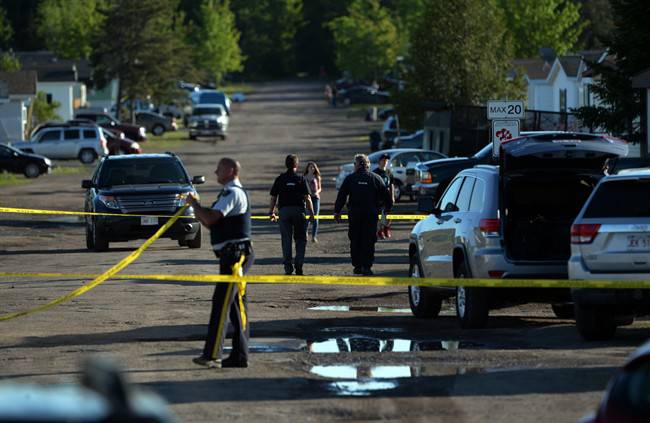 FILE - RCMP investigators work at the home of shooting suspect Justin Bourque in Moncton, N.B. on Sunday, June 8, 2014.