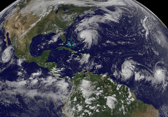 This image made available by the NOAA-NASA GOES Project shows tropical weather systems Hurricane Norma, left, on the Pacific Ocean side of Mexico; Jose, center, east of Florida; Tropical Depression 15, second from right, north of South America, and Tropical Storm Lee, right, north of eastern Brazil, on Saturday, Sept. 16, 2017 at 2:45 p.m. EDT.